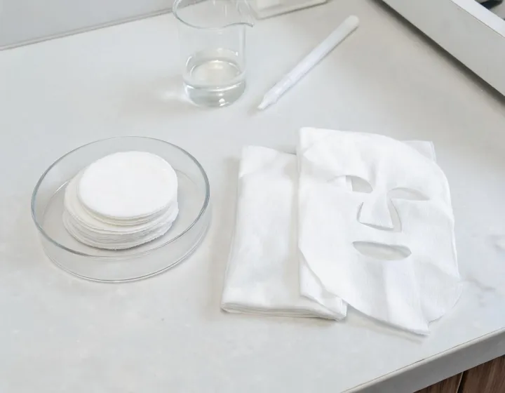 toner pad vs sheet mask on a cosmetics bench, illustration only